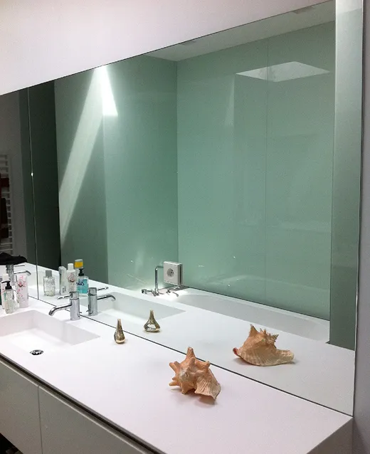 Salle de bain avec grande paroi de douche en verre opaque vert